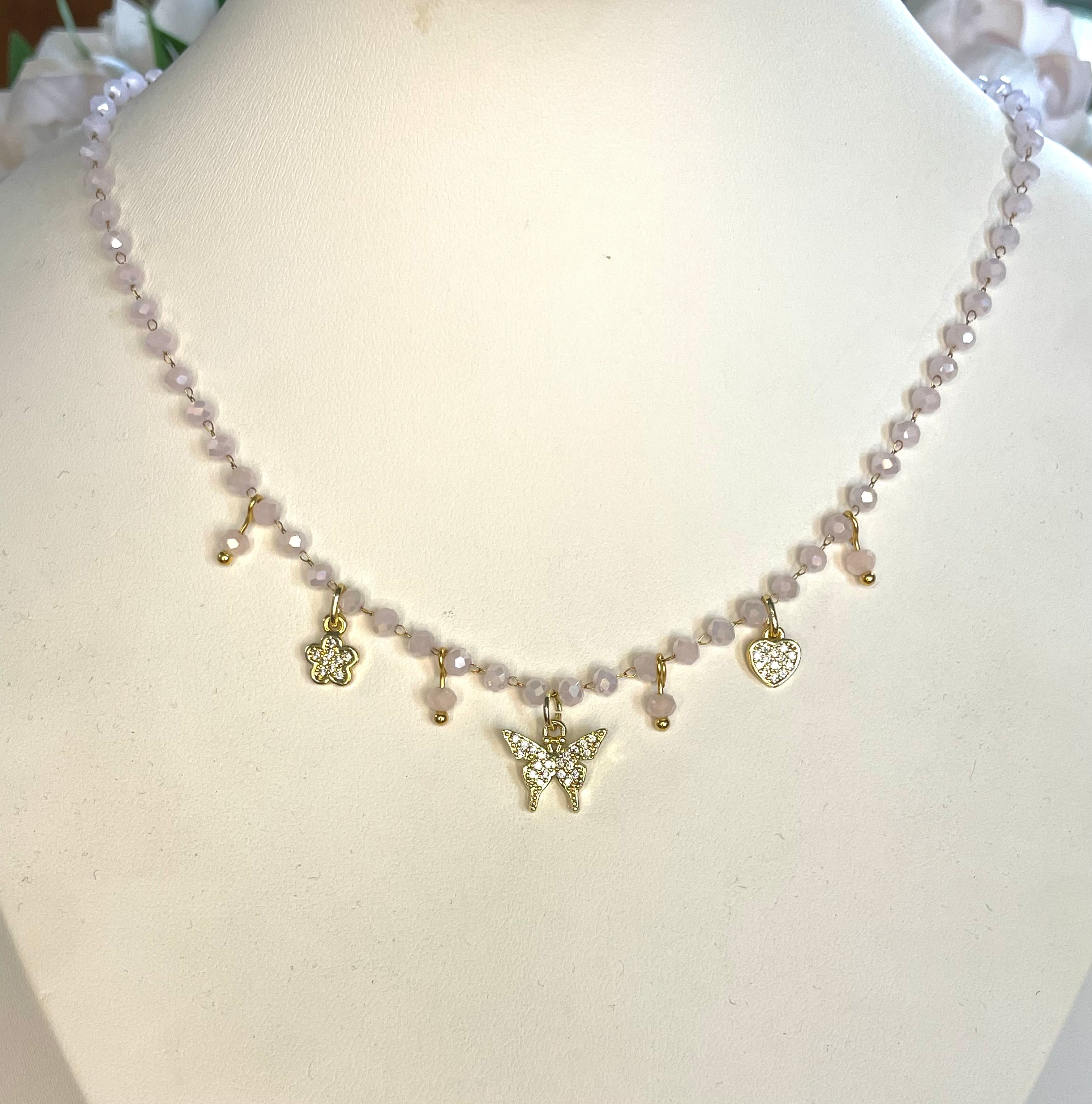 Girocollo rosario con cristalli rosa e charms